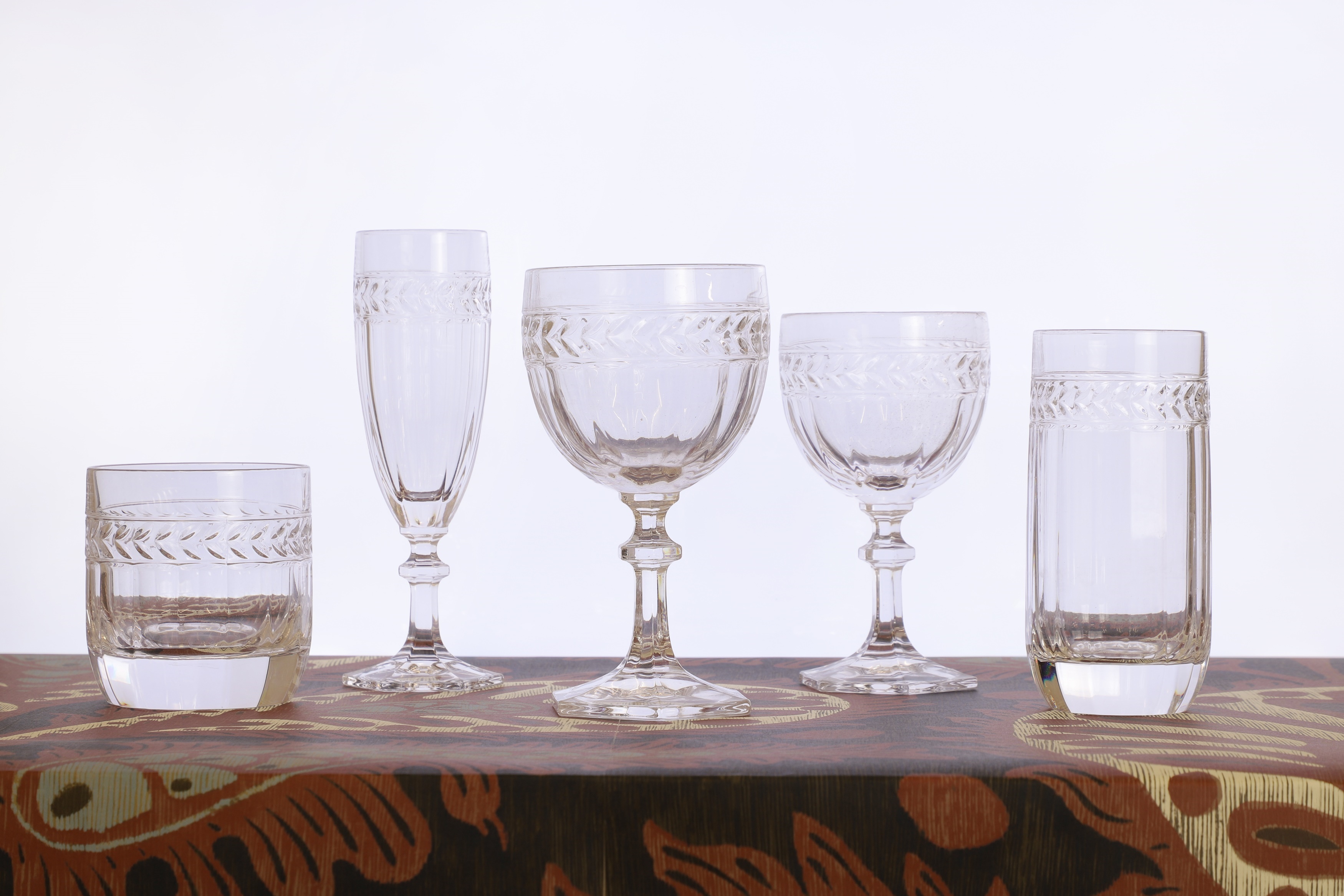 A Villeroy & Boch 'Miss Desiree' glass suite of recent manufacture, each with pressed glass laurel and panel decoration and raised on an hexagonal base (£400-600)
